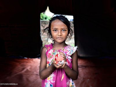 Meem (5) is holding her toy by standing inside the Child protection hub supported by Unicef